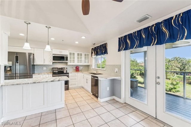 kitchen with white cabinets, light stone counters, visible vents, and appliances with stainless steel finishes