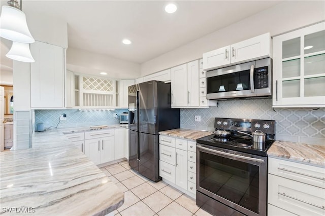 kitchen featuring light tile patterned floors, light stone counters, stainless steel appliances, white cabinetry, and open shelves