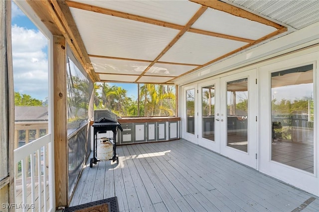 unfurnished sunroom featuring plenty of natural light and french doors