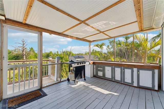 wooden terrace with a sink and a grill