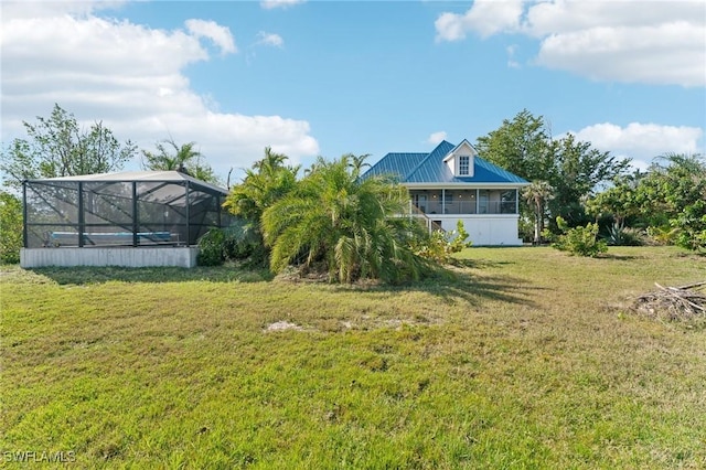 view of yard with glass enclosure