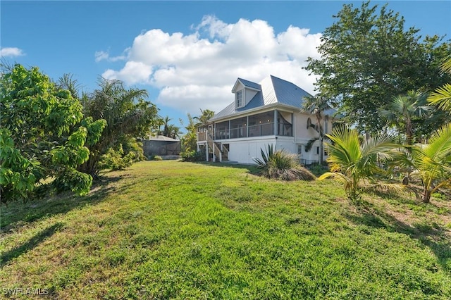 view of yard with stairs and a sunroom