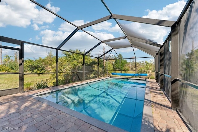 pool featuring glass enclosure and a patio