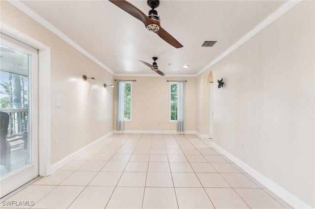 spare room featuring visible vents, crown molding, light tile patterned floors, baseboards, and ceiling fan