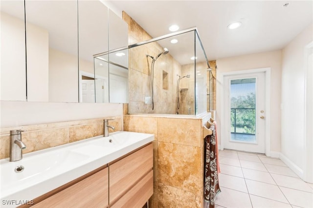 full bath featuring a shower stall, recessed lighting, double vanity, and tile patterned floors