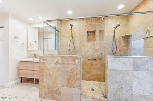 bathroom with a stall shower, recessed lighting, tile patterned flooring, baseboards, and vanity