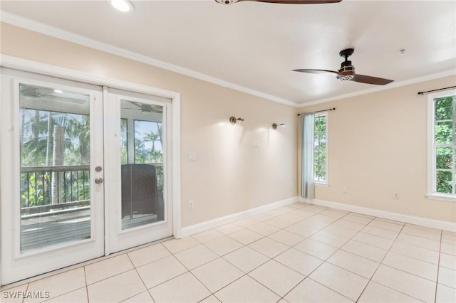 empty room with light tile patterned floors, a wealth of natural light, and ornamental molding