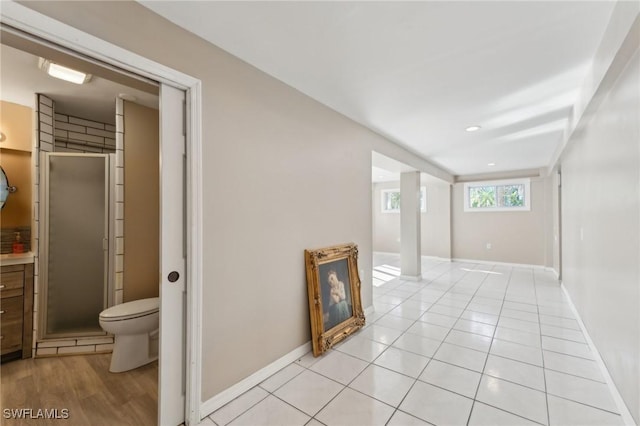 hallway with light tile patterned floors, recessed lighting, and baseboards