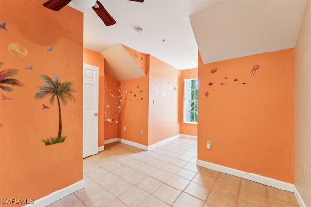 unfurnished room with light tile patterned floors, baseboards, and ceiling fan