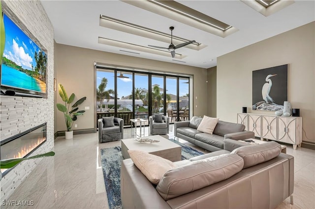 836 Miramar Ct, Cape Coral, FL 33904 - living room with baseboards, ceiling fan, and a fireplace