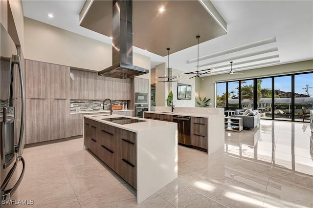 836 Miramar Ct, Cape Coral, FL 33904 - kitchen with island exhaust hood, fridge with ice dispenser, modern cabinets, and a center island with sink
