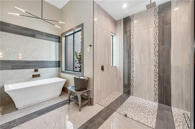 836 Miramar Ct, Cape Coral, FL 33904 - full bath featuring a freestanding tub, a notable chandelier, marble finish floor, a walk in shower, and tile walls