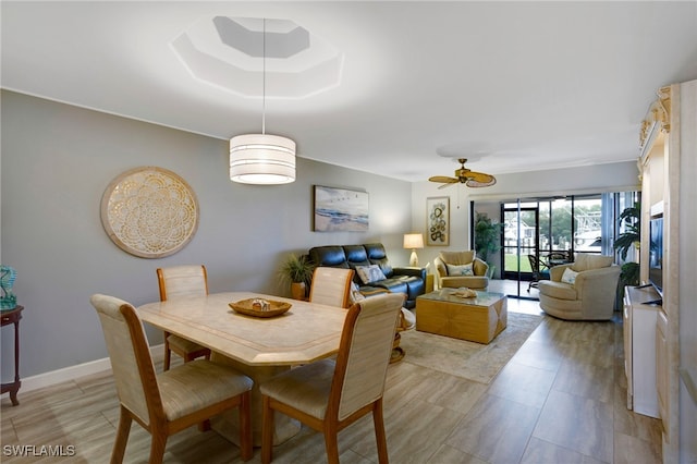 dining room featuring a ceiling fan and baseboards