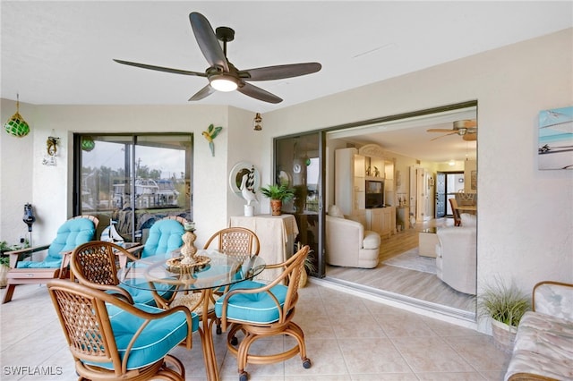 dining space with light tile patterned floors and ceiling fan