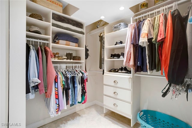 walk in closet with tile patterned floors