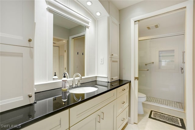 bathroom featuring visible vents, toilet, a stall shower, and vanity