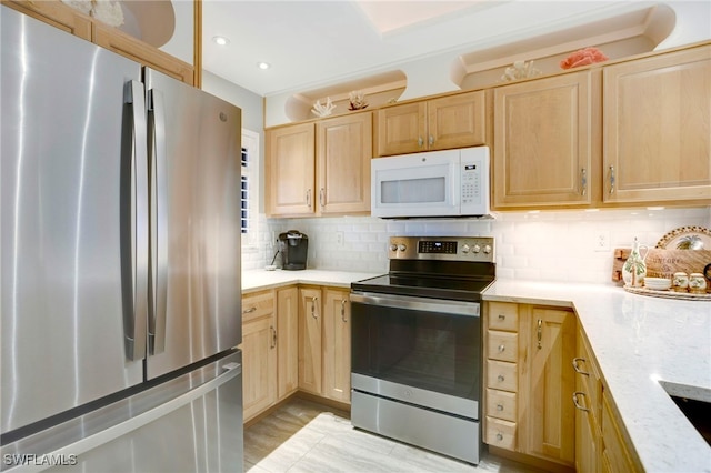 kitchen with decorative backsplash, light brown cabinets, and appliances with stainless steel finishes