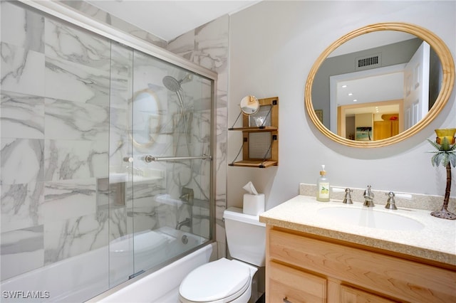 full bathroom with visible vents, shower / bath combination with glass door, vanity, and toilet