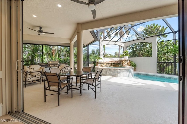 view of patio / terrace featuring outdoor dining area, a lanai, a ceiling fan, and a pool with connected hot tub