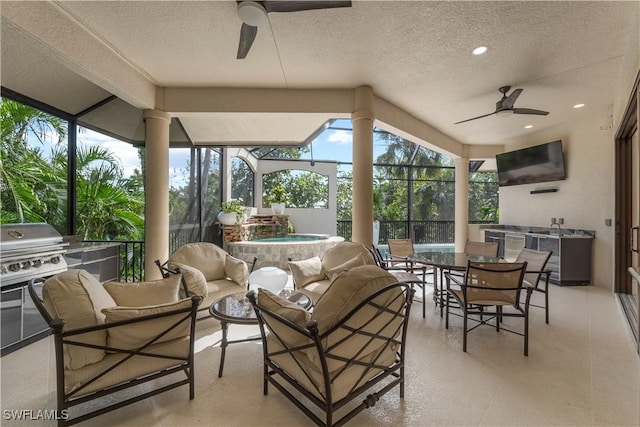 view of patio with glass enclosure, exterior kitchen, an in ground hot tub, and an outdoor hangout area