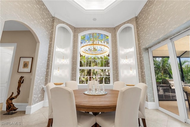 dining space featuring light tile patterned floors, wallpapered walls, crown molding, and baseboards