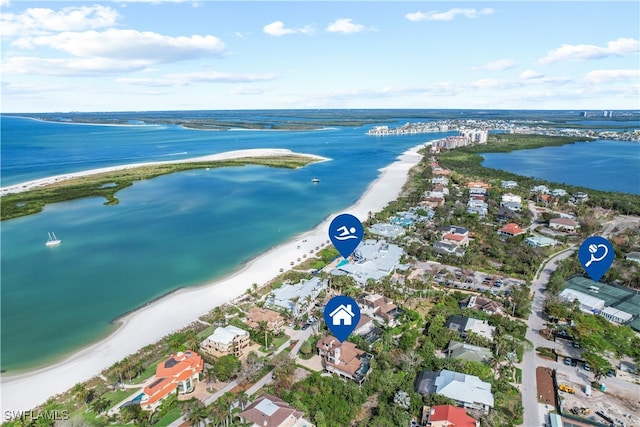 aerial view with a view of the beach, a water view, and a residential view