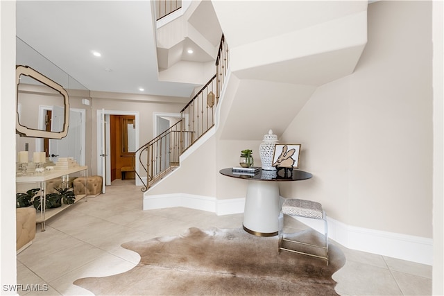 interior space with tile patterned flooring, recessed lighting, and baseboards