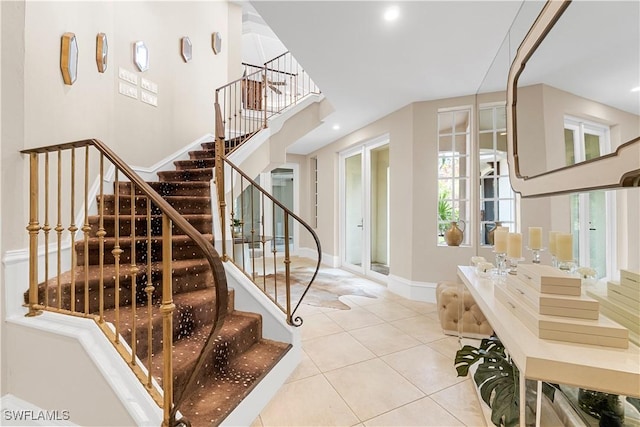 staircase with tile patterned flooring and baseboards