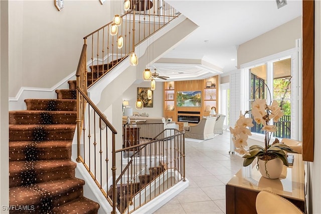 stairway with tile patterned floors and ceiling fan