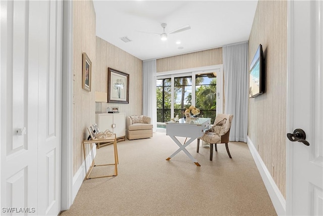 living area with baseboards, visible vents, wallpapered walls, and a ceiling fan