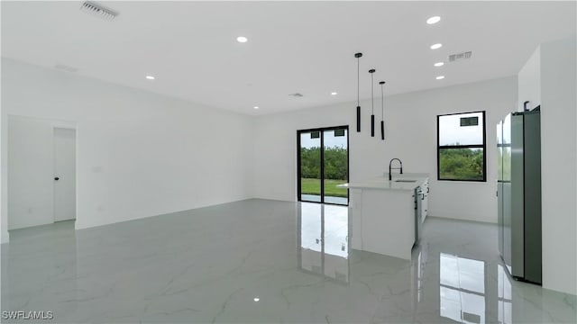 empty room with recessed lighting, visible vents, marble finish floor, and a sink