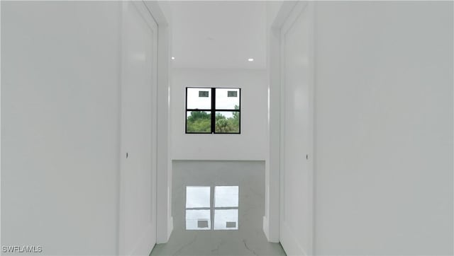 corridor with marble finish floor