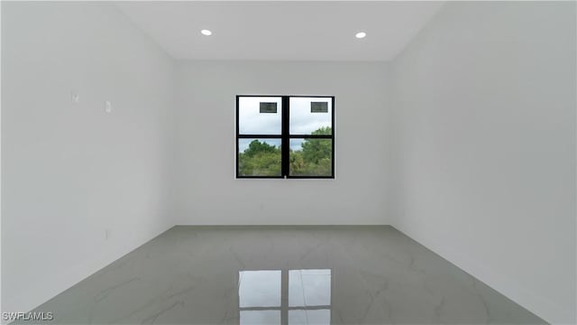 empty room with recessed lighting and marble finish floor