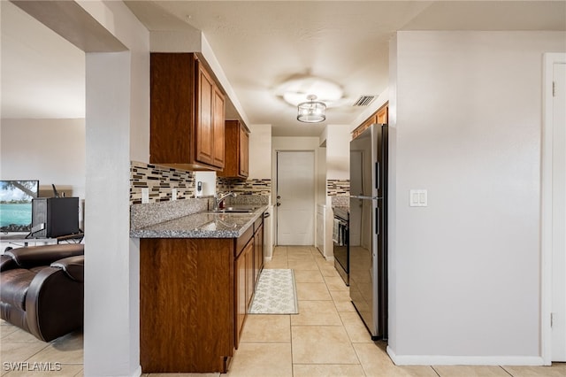 2184 Barry Dr, Fort Myers, FL 33907 - kitchen featuring tasteful backsplash, visible vents, light tile patterned floors, black appliances, and a sink