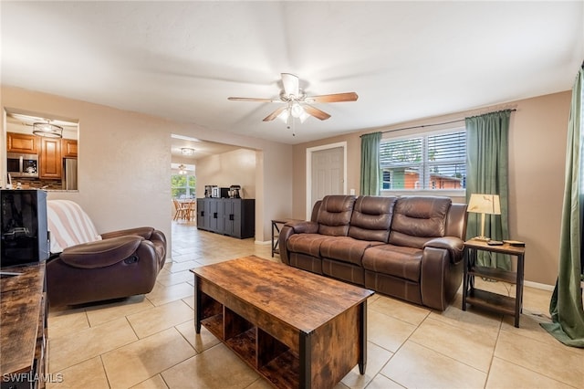 2184 Barry Dr, Fort Myers, FL 33907 - living room featuring a wealth of natural light, baseboards, ceiling fan, and light tile patterned floors