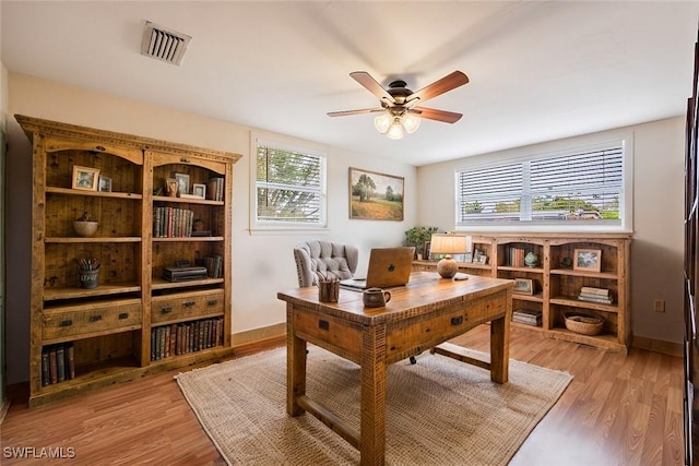 2184 Barry Dr, Fort Myers, FL 33907 - office featuring light wood-type flooring, visible vents, and a healthy amount of sunlight