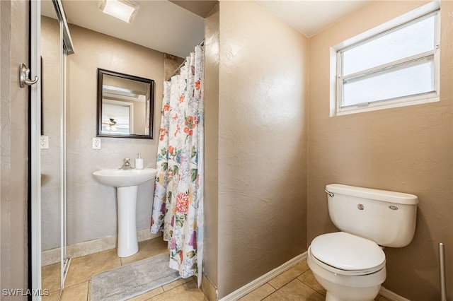 2184 Barry Dr, Fort Myers, FL 33907 - full bathroom featuring a shower with curtain, toilet, and baseboards