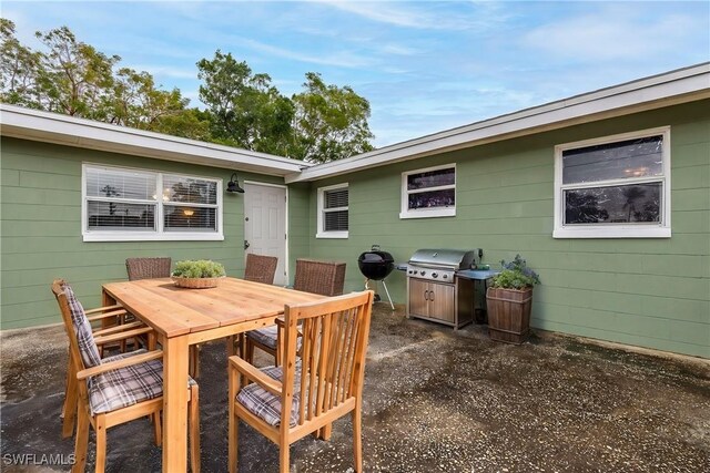 2184 Barry Dr, Fort Myers, FL 33907 - view of patio with a grill and outdoor dining space