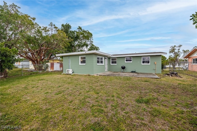 2184 Barry Dr, Fort Myers, FL 33907 - rear view of property featuring a patio area, a fenced backyard, and a lawn