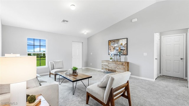 living room featuring lofted ceiling, light colored carpet, visible vents, and baseboards