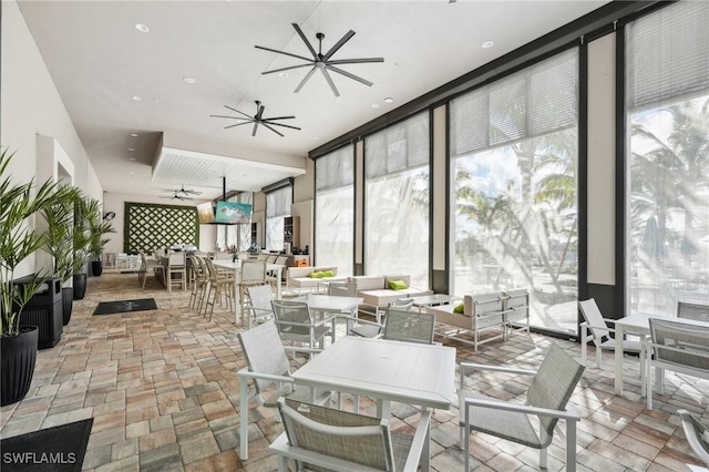 interior space with outdoor dining space and a ceiling fan