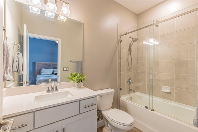 full bathroom featuring combined bath / shower with glass door, connected bathroom, toilet, and vanity