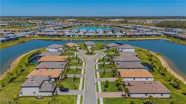 birds eye view of property with a residential view and a water view