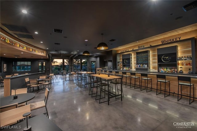 dining space with visible vents and concrete floors