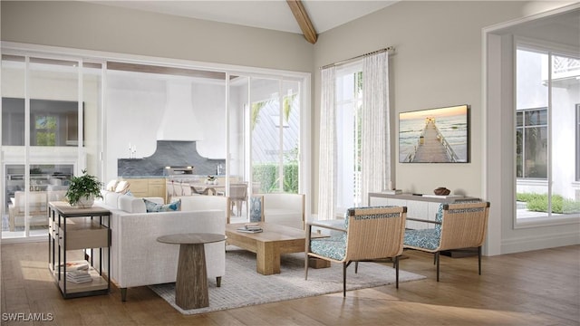 sitting room with beam ceiling, wood finished floors, and a wealth of natural light