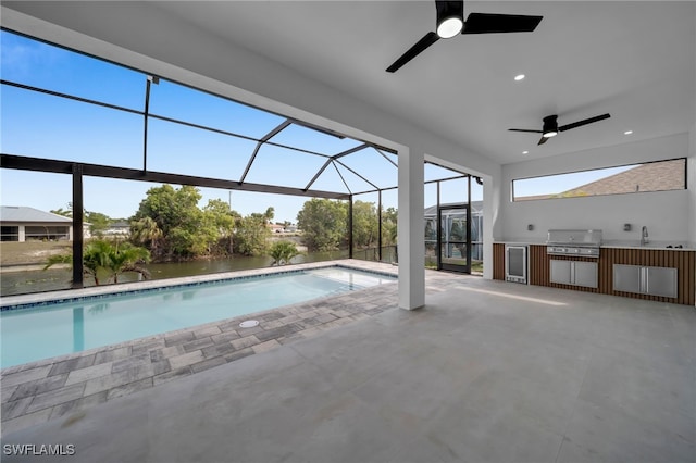 pool with area for grilling, a ceiling fan, exterior kitchen, a lanai, and a patio area