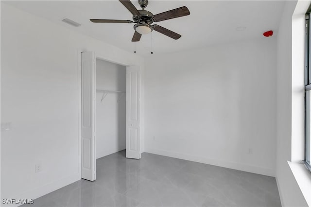 unfurnished bedroom with a ceiling fan, baseboards, visible vents, and a closet