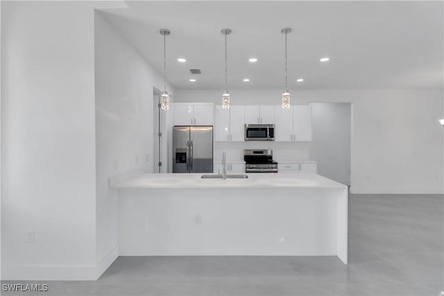 kitchen featuring visible vents, light countertops, appliances with stainless steel finishes, white cabinets, and a sink