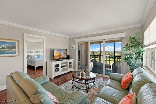 living room with crown molding, wood finished floors, and baseboards