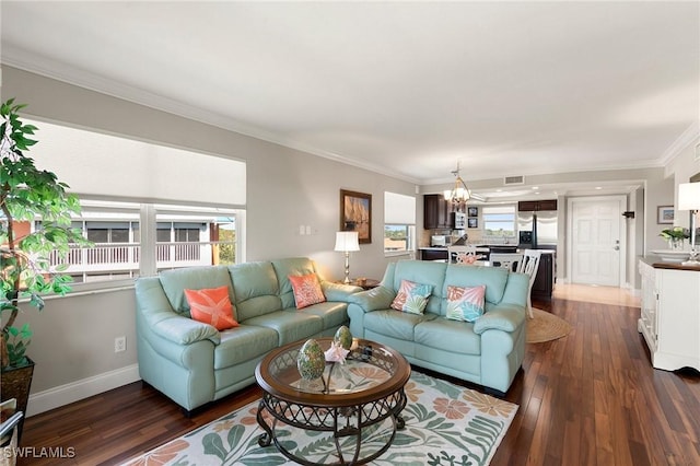 living room with visible vents, crown molding, baseboards, an inviting chandelier, and dark wood-style flooring